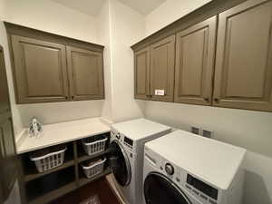 Laundry room with cabinets and independent washer and dryer