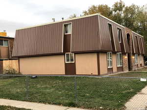 View of side of home featuring a lawn