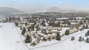 Snowy aerial view featuring a mountain view