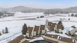 Snowy aerial view featuring a mountain view