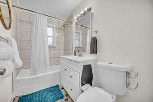 Full bathroom with shower / bath combo, vanity, and toilet