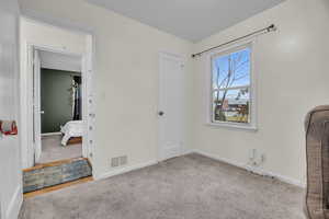 Bedroom featuring light colored carpet