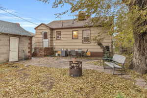 Rear view of house featuring central AC unit and a patio area