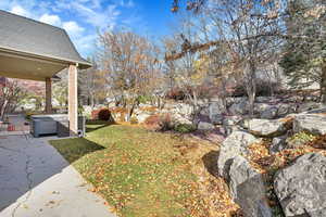 View of yard with a patio and a hot tub