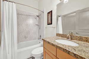 Second Full bathroom with shower / tub combo with curtain, vanity, and toilet Main floor