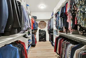 Walk in closet featuring light wood-type flooring