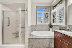 Main Bathroom with vanity and independent shower and bath