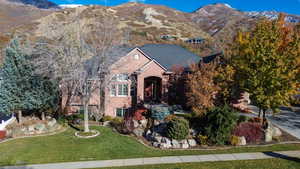 View of front of property with a mountain view and a front yard