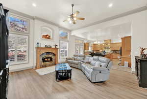 Living room featuring light hardwood / wood-style flooring, plenty of natural light, and crown molding