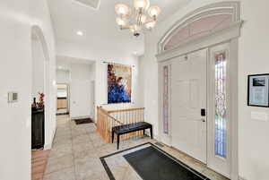 Entryway featuring light wood-type flooring and a notable chandelier