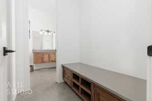 Mudroom with light tile patterned floors and sink