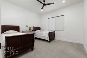 Carpeted bedroom featuring ceiling fan