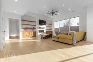 Living room featuring ceiling fan and light hardwood / wood-style floors