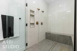 Full bath featuring tiled shower