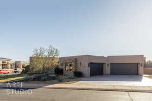 Pueblo-style home with a garage