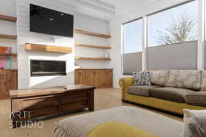 Living room with a fireplace and light hardwood / wood-style floors