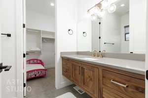 Bathroom with tile patterned flooring and vanity