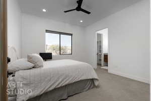 Carpeted bedroom with ensuite bathroom, a spacious closet, and ceiling fan