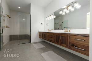 Bathroom with tile patterned floors, vanity, and a shower with shower door