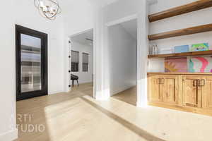 Interior space featuring a notable chandelier and light wood-type flooring