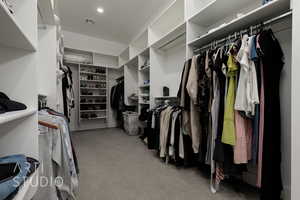 Walk in closet featuring light carpet