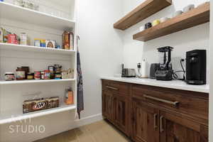 Interior space with dark brown cabinets and light hardwood / wood-style floors