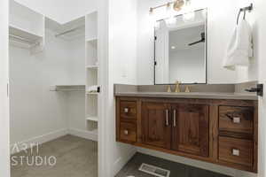 Bathroom with tile patterned floors, ceiling fan, and vanity