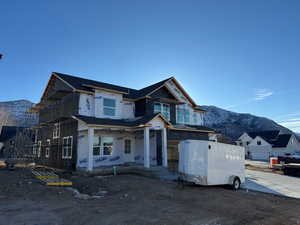 View of front facade featuring a mountain view and covered porch