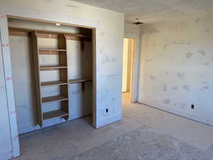 Unfurnished bedroom featuring a textured ceiling