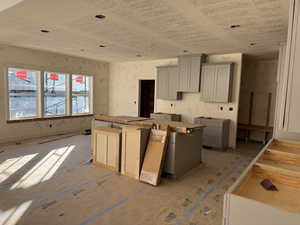 Kitchen with gray cabinetry and a center island