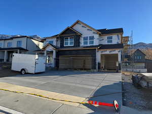 View of front facade featuring a mountain view and a garage