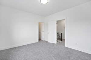 Unfurnished bedroom with carpet flooring