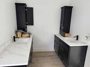 Laundry area featuring sink and light hardwood / wood-style floors