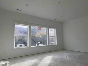 Empty room with plenty of natural light and a mountain view