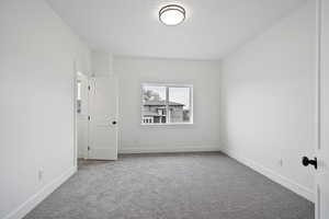 Unfurnished room featuring carpet floors