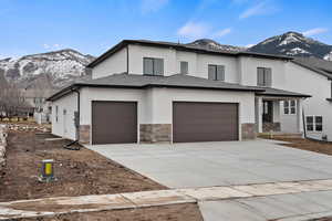 Prairie-style home with a mountain view and a garage