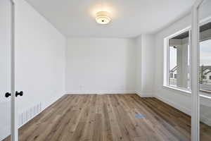 Spare room featuring hardwood / wood-style flooring