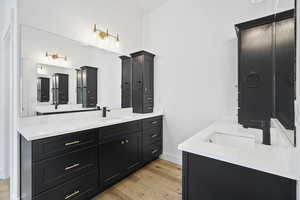 Bathroom featuring vanity and hardwood / wood-style floors