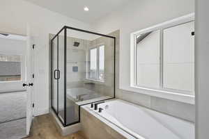 Bathroom with wood-type flooring and plus walk in shower