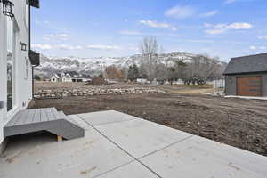 View of yard with a mountain view and a patio