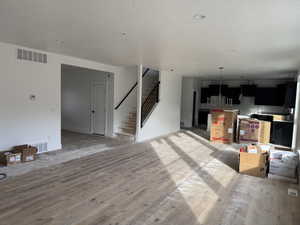 Living room with a textured ceiling and hardwood / wood-style flooring