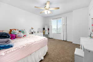 Bedroom featuring ceiling fan and light carpet