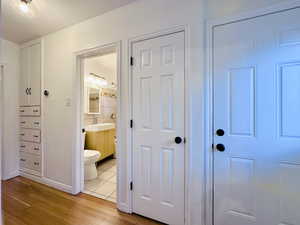 Hall with light hardwood / wood-style flooring and sink