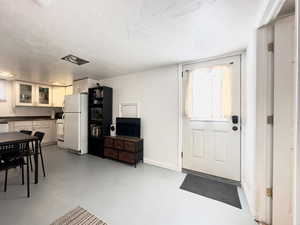 Foyer entrance featuring a textured ceiling