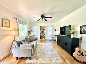 Living room featuring light hardwood / wood-style floors and ceiling fan