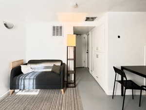 Bedroom featuring concrete flooring