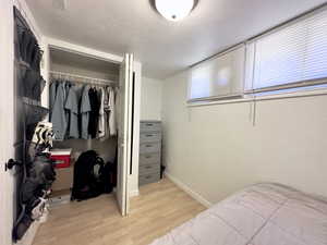 Bedroom featuring light hardwood / wood-style floors and a closet