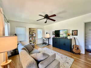 Living room featuring light hardwood / wood-style floors and ceiling fan