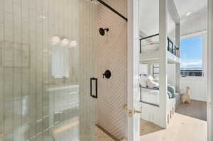 Bunkroom Bathroom featuring hardwood / wood-style flooring and an enclosed shower