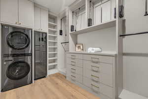 Master closet with built in cabinets, and stacked washer / dryer